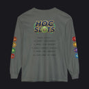 A dark gray long-sleeve t-shirt with a colorful 'HOC SLOTS 10' graphic on the chest and multicolored hexagonal patch graphics on both sleeves, displayed against a solid white background.