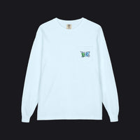 A light blue long-sleeve crewneck pocket t-shirt with a small circular graphic printed on the chest pocket, displayed flat against a white background.