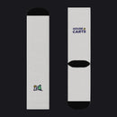 A pair of white crew socks shown from both the front and back views against a plain white background. The front view features a small multicolor logo near the foot, while the back view features the 'HOUSE OF CARTS' logo in navy blue and gold near the calf, with a black ribbed heel and toe.