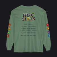 A sage green long-sleeve t-shirt with a humorous 'HOC Slots' gaming graphic on the back. The graphic features a gold and blue gradient 'HOC SLTS' logo with a green gem outline, followed by mock statistics in dark green text.