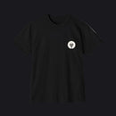 Black t-shirt with a small green logo on a gray background