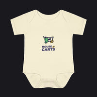 A cream-colored short-sleeve baby bodysuit with a 'HOUSE OF CARTS' graphic printed on the chest, displayed against a solid white background.