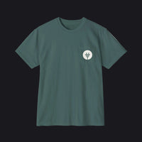 A dark teal green short-sleeve crewneck pocket t-shirt with a small circular chest graphic, displayed flat against a solid white background.