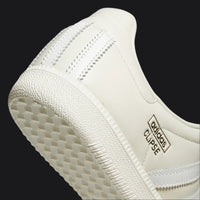 Close-up of a white sneaker with 'Gloves of the Eclipse' branding on a white background