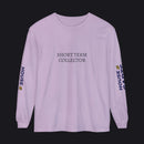 A light purple long-sleeve t-shirt with 'SHORT TERM COLLECTOR' printed in black across the chest, featuring 'HOUSE OF CARES' in navy and yellow on both sleeves, displayed on a clean white background.