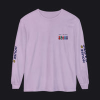 A light purple long-sleeve t-shirt with a small chest graphic and military-style ribbons, featuring 'HOUSE CARDS' printed vertically on both sleeves.