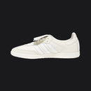 White sneaker with three stripes on a white background