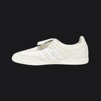 White sneaker with three stripes on a white background