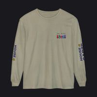 A sage green long-sleeve t-shirt with 'HOUSE CARDS' printed in blue on both sleeves, featuring a small multicolor military-style ribbon graphic on the left chest.