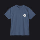 A slate blue crewneck pocket t-shirt with a small white circular chest graphic, displayed flat against a clean white background.