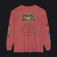 A dusty rose long-sleeve t-shirt with a graphic print on the back reading 'HOC SLOTS 2026 STATS' and various colorful hexagonal patches printed down both sleeves, shown against a plain white background.