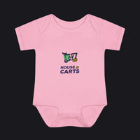 A light pink short-sleeve baby bodysuit with a graphic on the chest showing a green shopping cart and the text 'HOUSE OF CARTS' in navy and yellow, displayed on a clean white background.