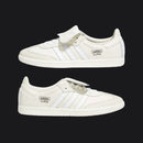 Pair of white Adidas Clipse sneakers on a black background