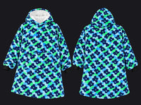 Front and back views of a hooded sweatshirt featuring a blue, green, and navy floral camouflage pattern, with a white fleece-lined hood and black cuffs.