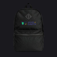 A black backpack with a front zippered pocket and a top handle, featuring a custom printed logo on the front that reads 'HOUSE TO CARTS' in purple and yellow with a small green graphic, set against a plain white background.
